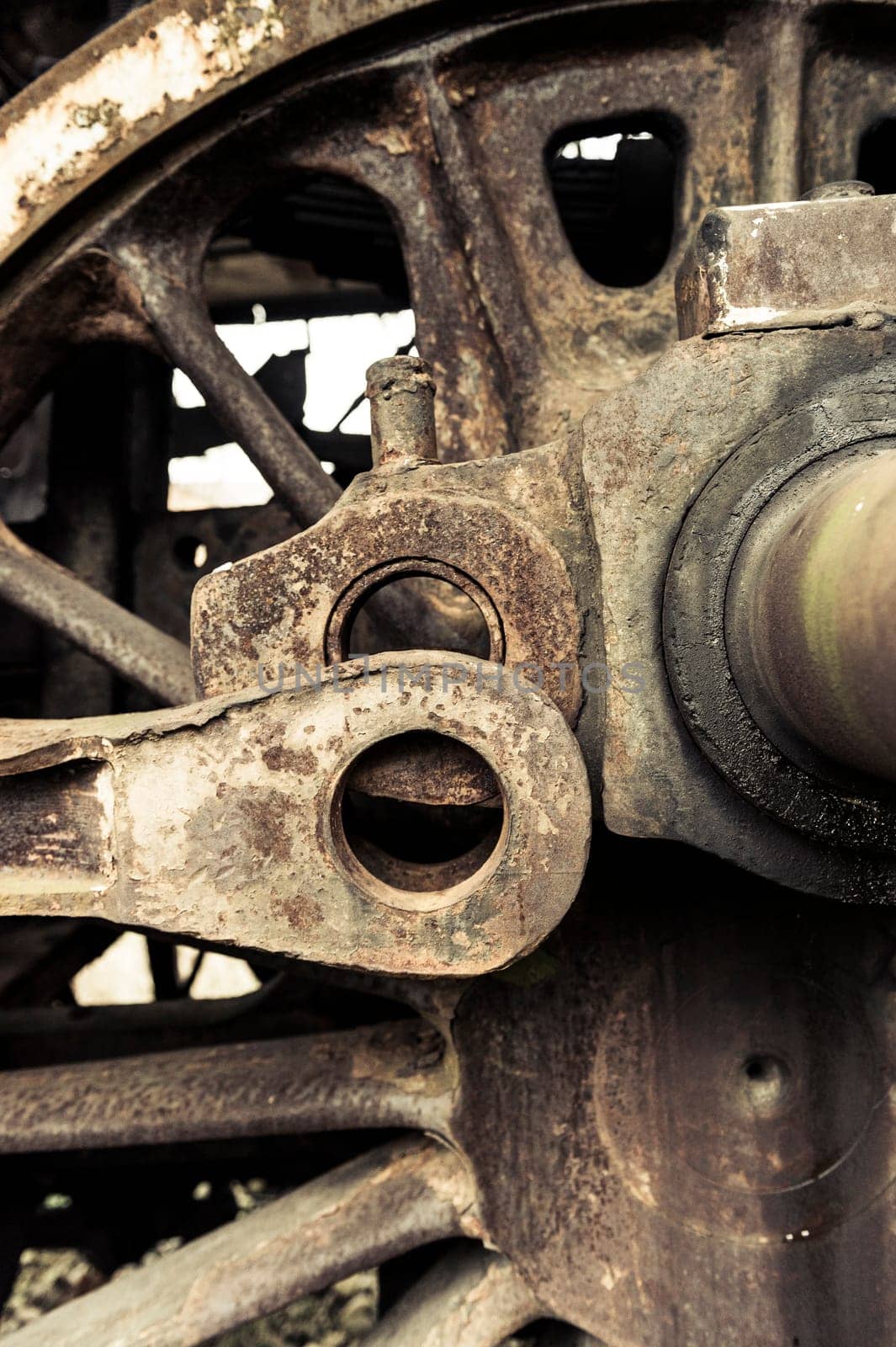 A fragment of an old damaged and rusty steam engine, old style type locomotive, vertical frame.