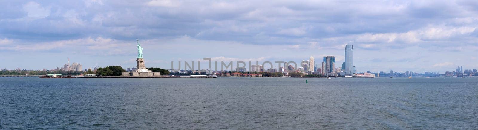 The Statue of Liberty (Liberty Enlightening the World), a colossal neoclassical sculpture on Liberty Island in the middle of New York Harbor, Manhattan. The statue is of a robed female figure representing Libertas, the Roman goddess of freedom, who bears a torch and a tabula ansata