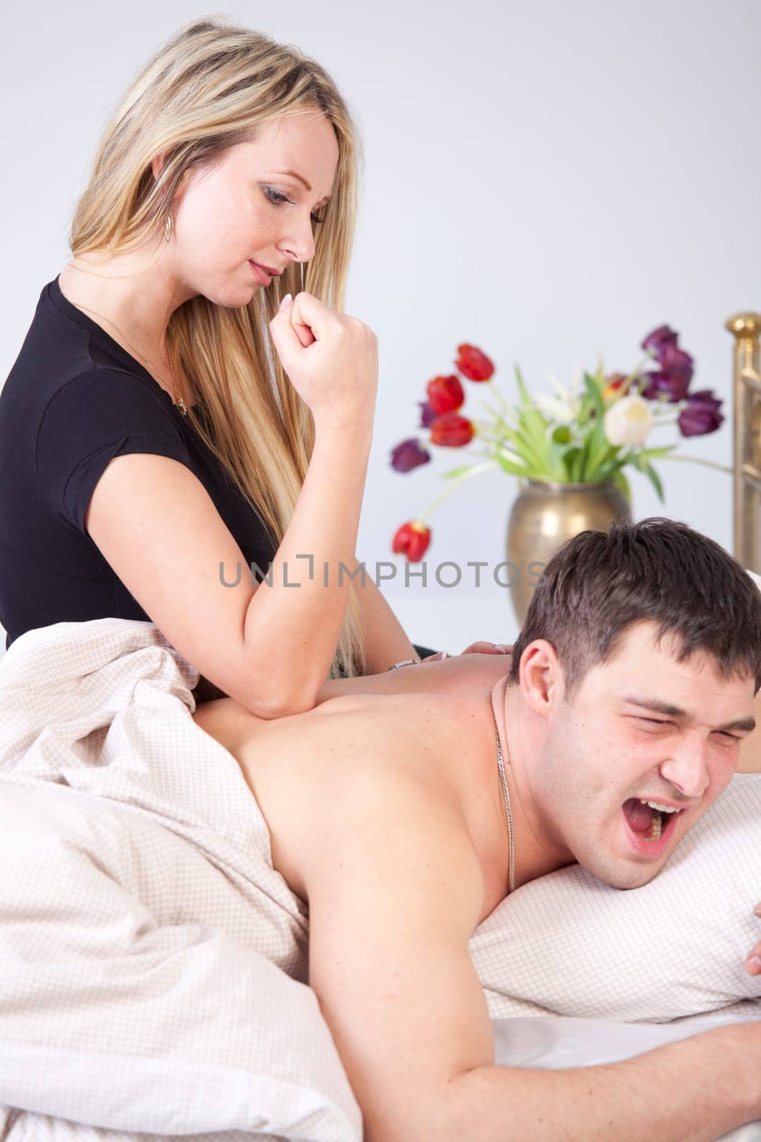Man receiving elbow massage from a woman