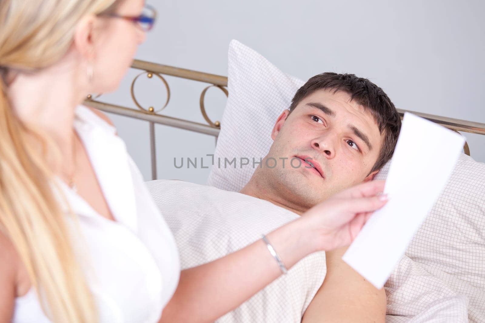 Shocked man on bed after a diagnostic report