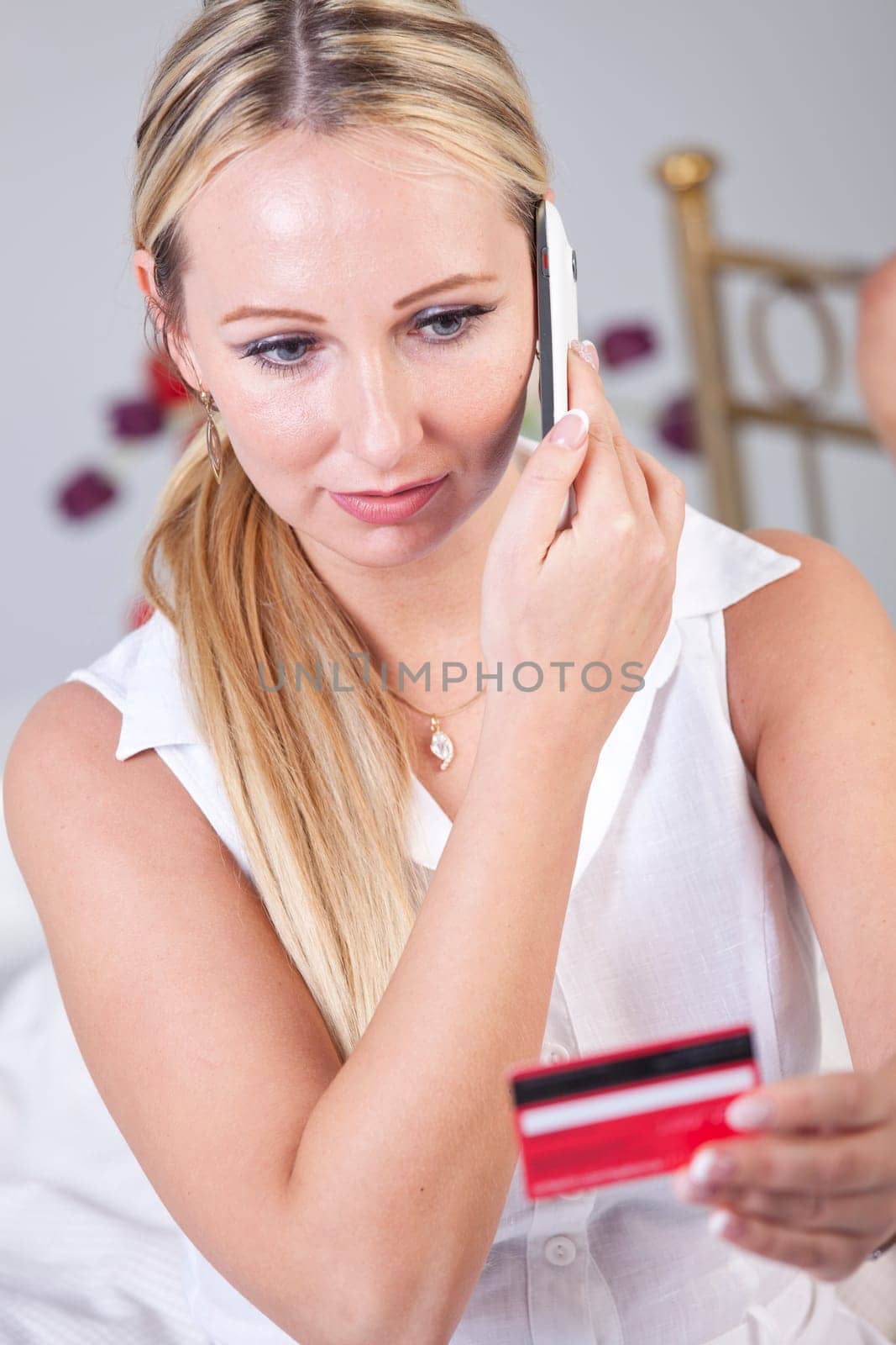 Woman making purchase on phone using her credit card