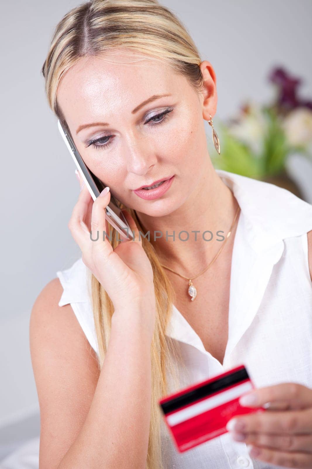 Woman making order on phone using her credit card
