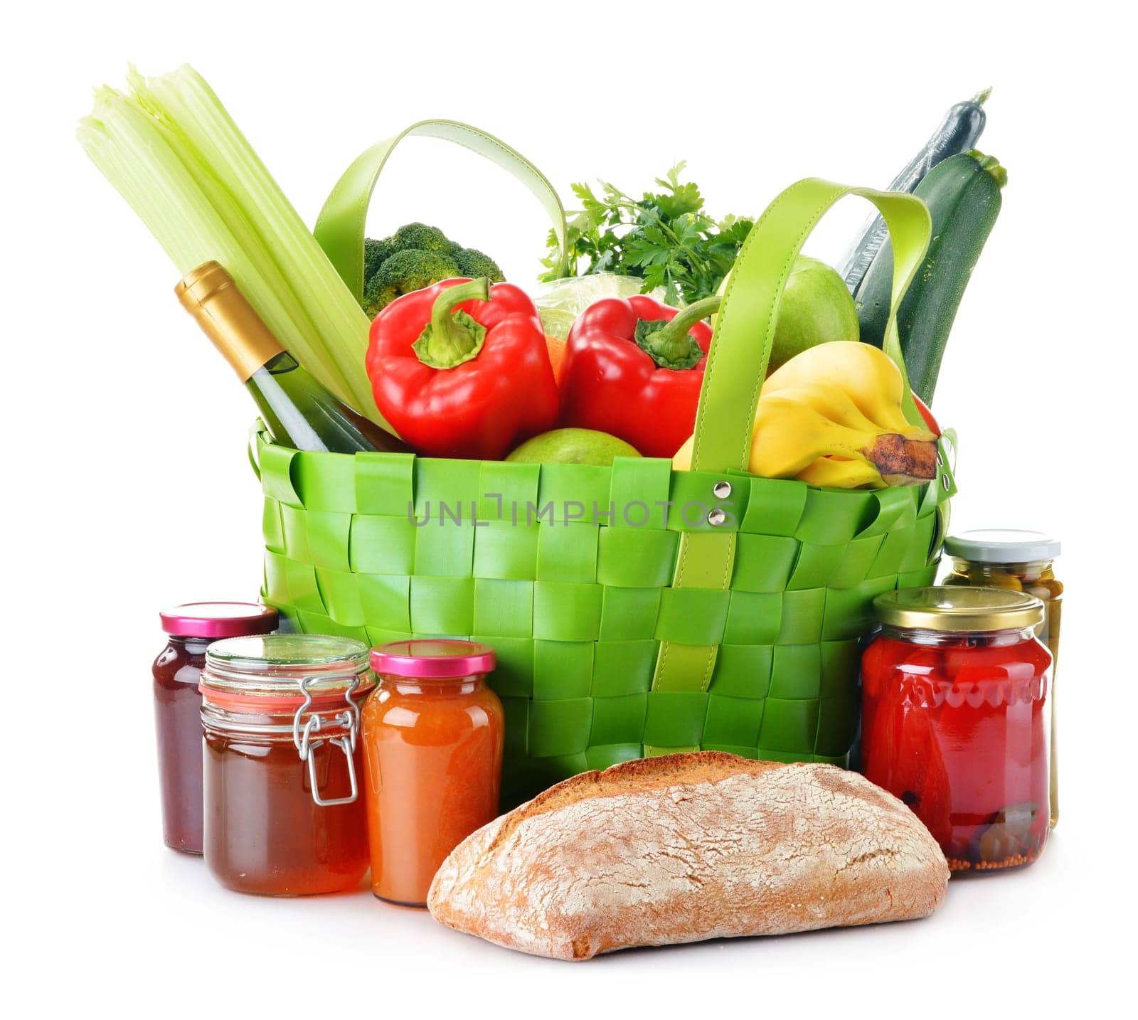 Green shopping bag with groceries isolated on white background