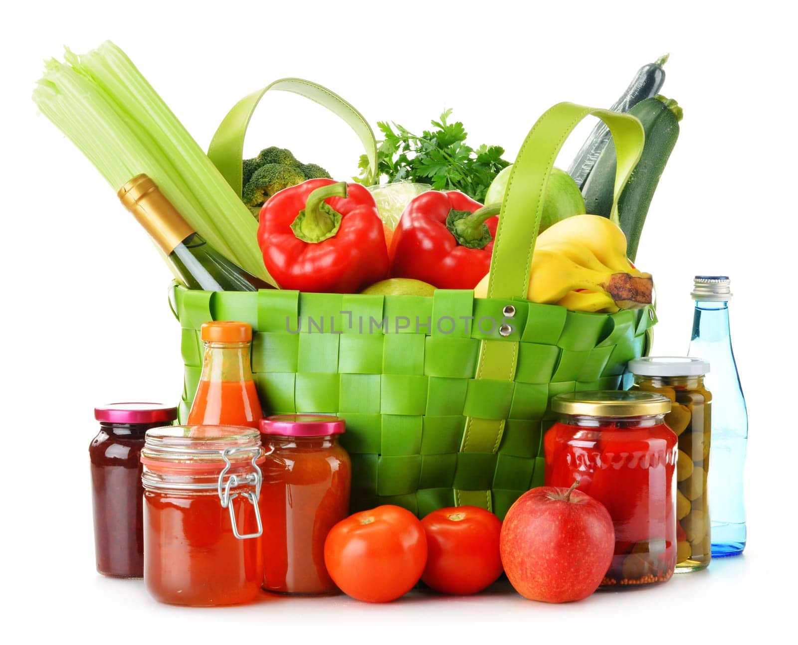 Green shopping bag with groceries isolated on white background