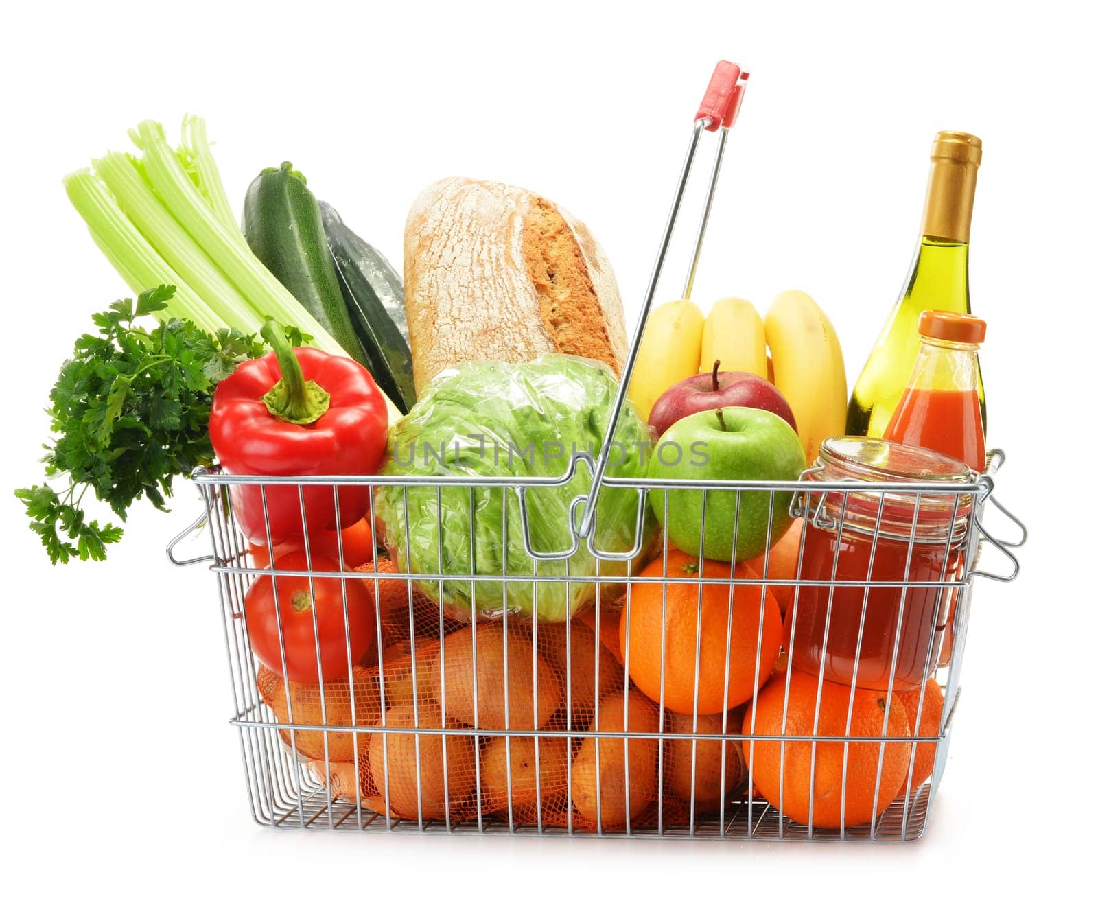 Wire shopping basket with groceries isolated on white