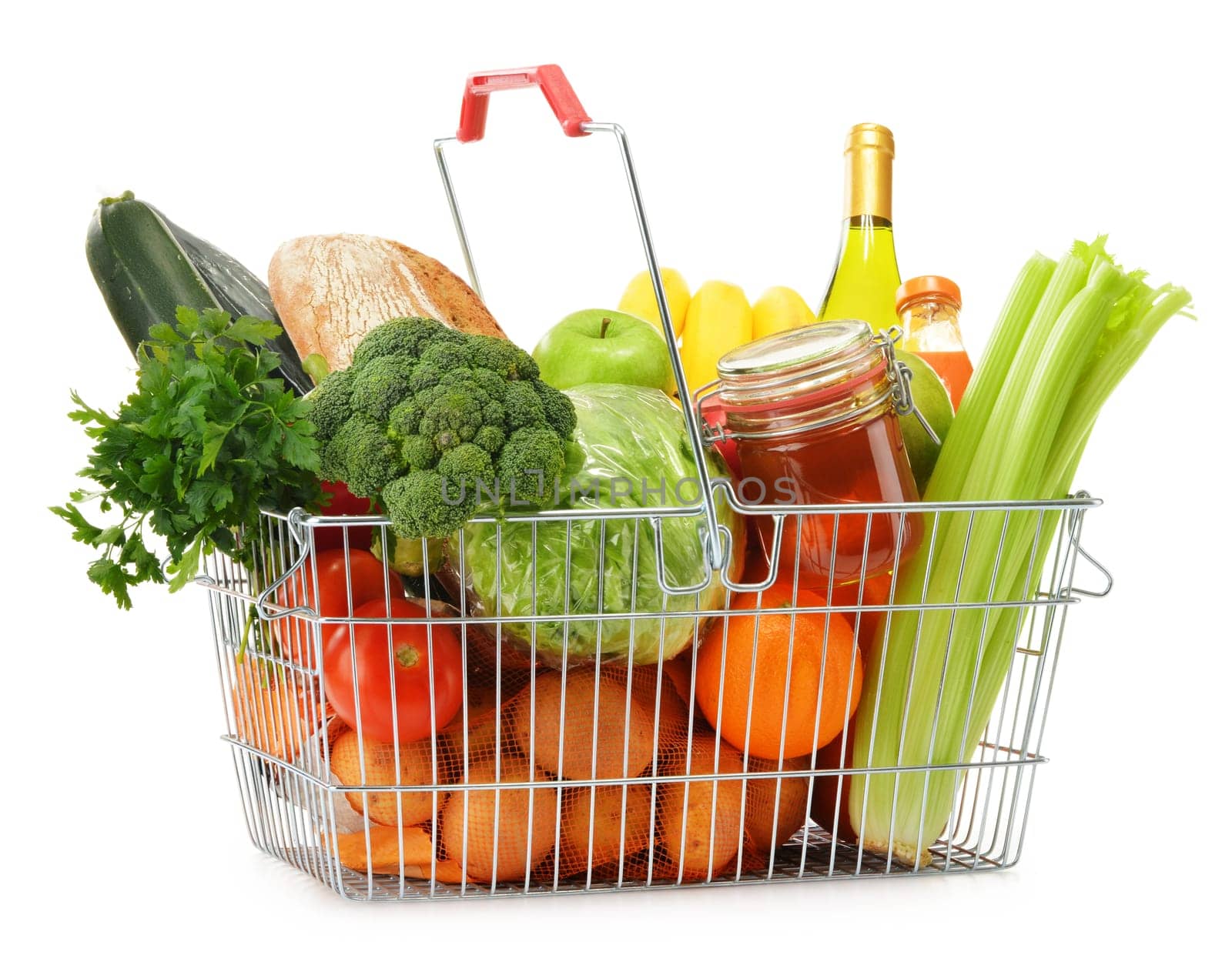Wire shopping basket with groceries isolated on white