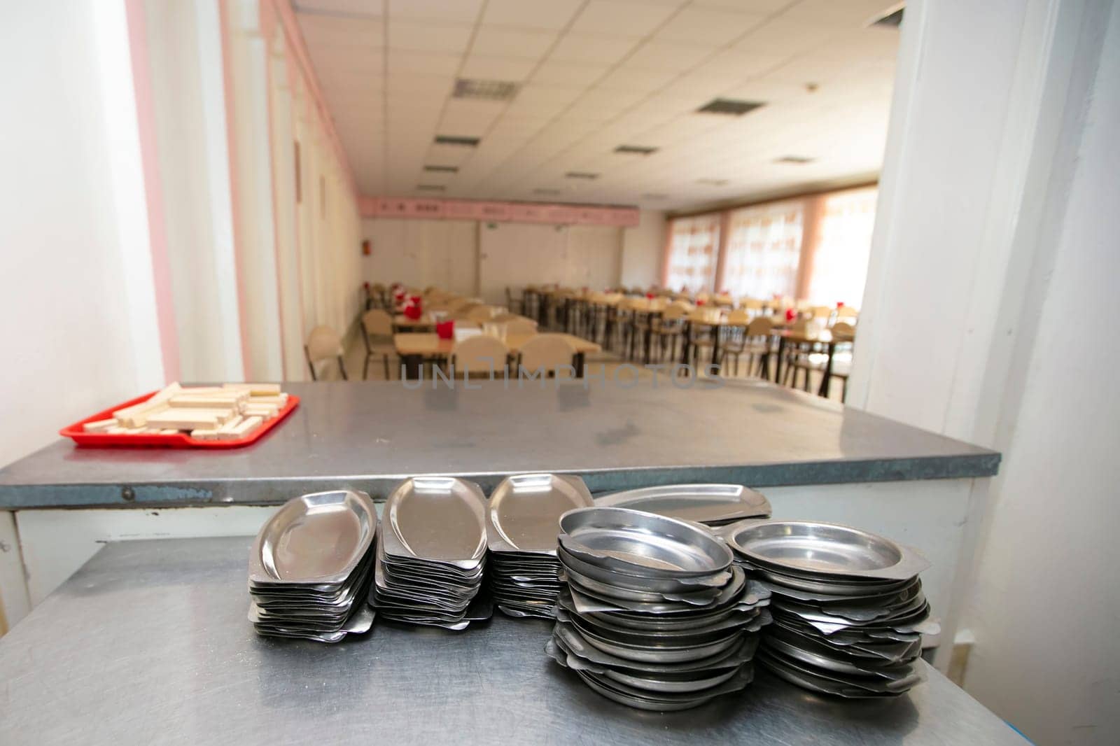 Iron plates in the background of a public dining room.School breakfast in a Russian school
