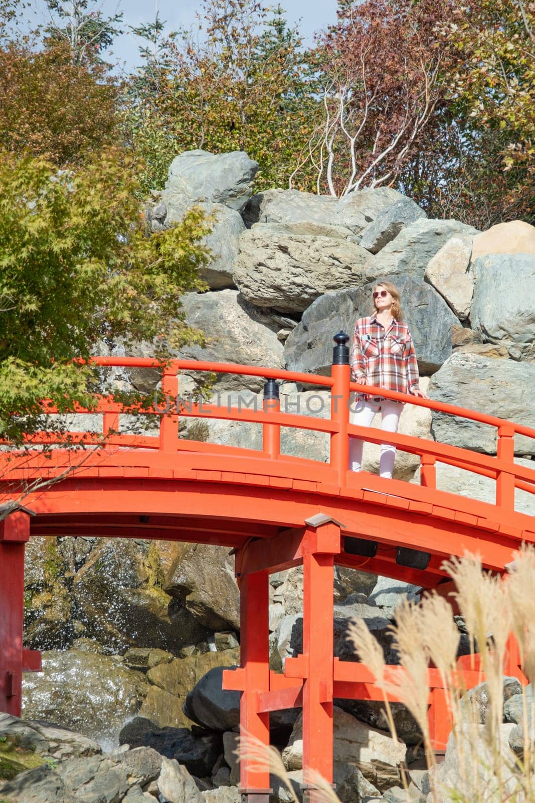 Woman enjoying nature walking in Japanese Garden by Desperada