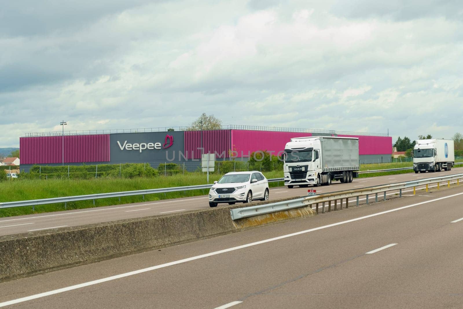 Montagny-le-Beaune, France - April 28, 2023: Pink facade of Veepee company building with logo.