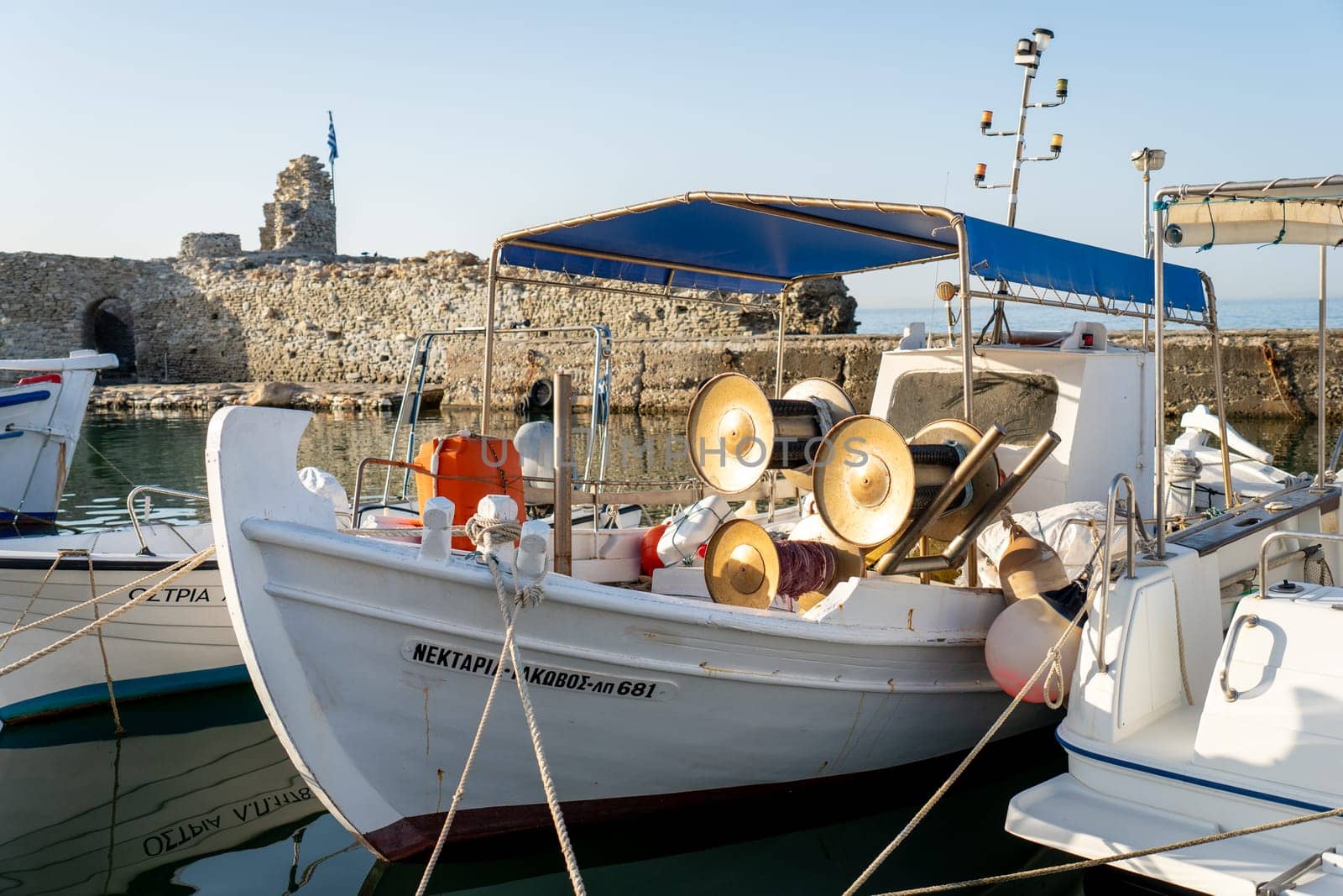 Boat moored in the port of Naoussa, Paros by LopezPastor