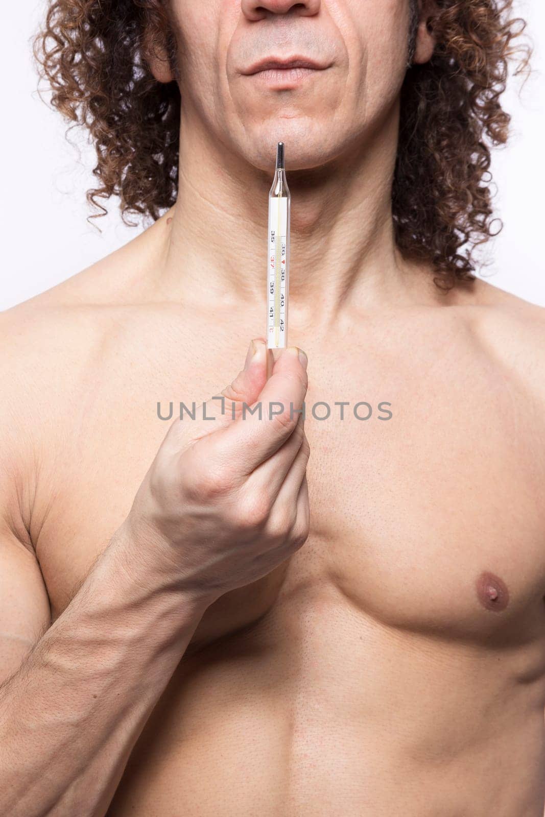 Cropped portrait of mediterranean looking man holding a mercury thermometer