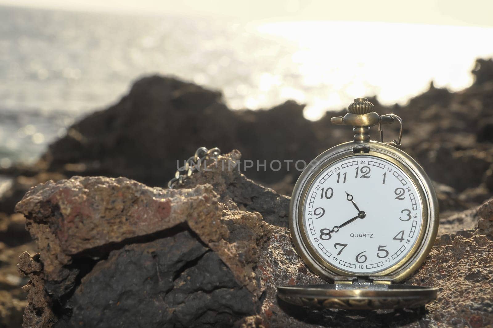 Time Concept Classic Vintage Pocket Clock on the Volcanic Rocks