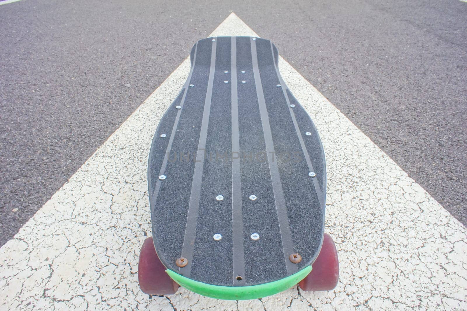 Vintage Style Longboard Black Skateboard on an Empty Asphalt Desert Road