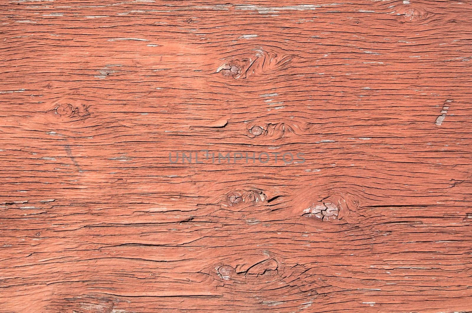 Old weathered plywood surface with faded paint as background
