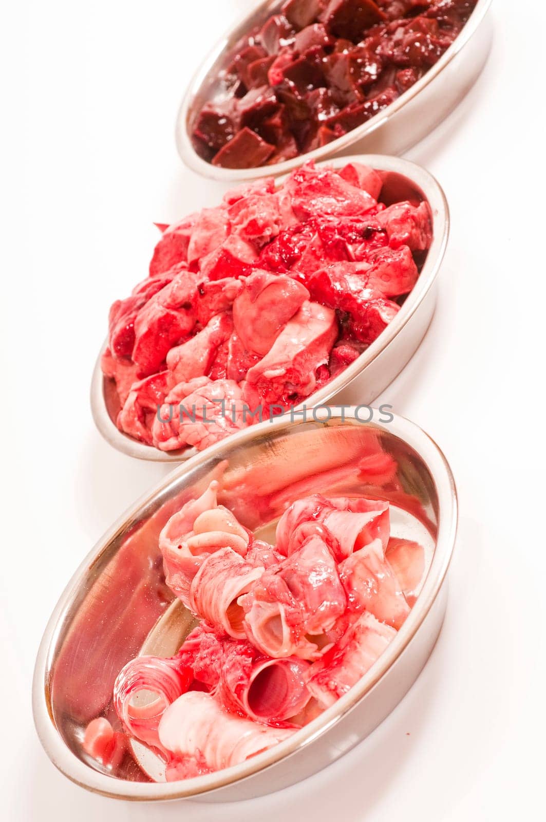 fresh cut offal (liver,lungs,heart,throat,spleen) for raw feeding in stainless steel bowls