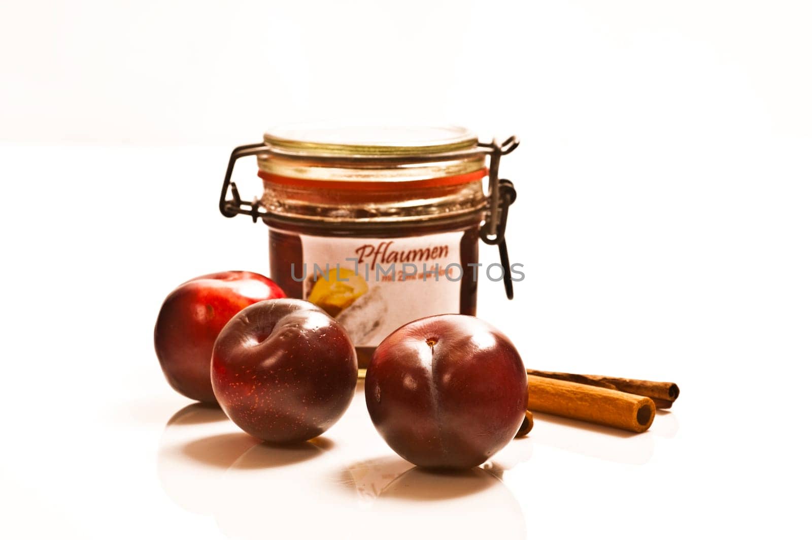 Preserved and fresh plums with cinnamon