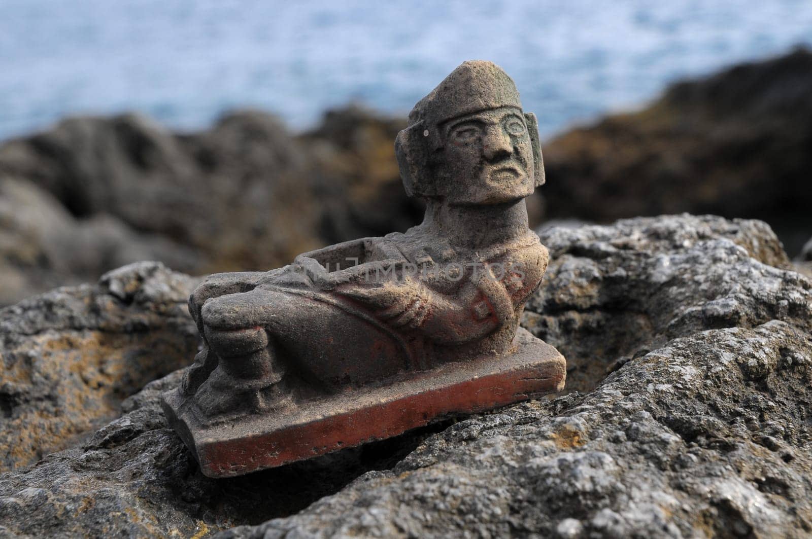 Ancient Maya Statue on the Rocks near Ocean