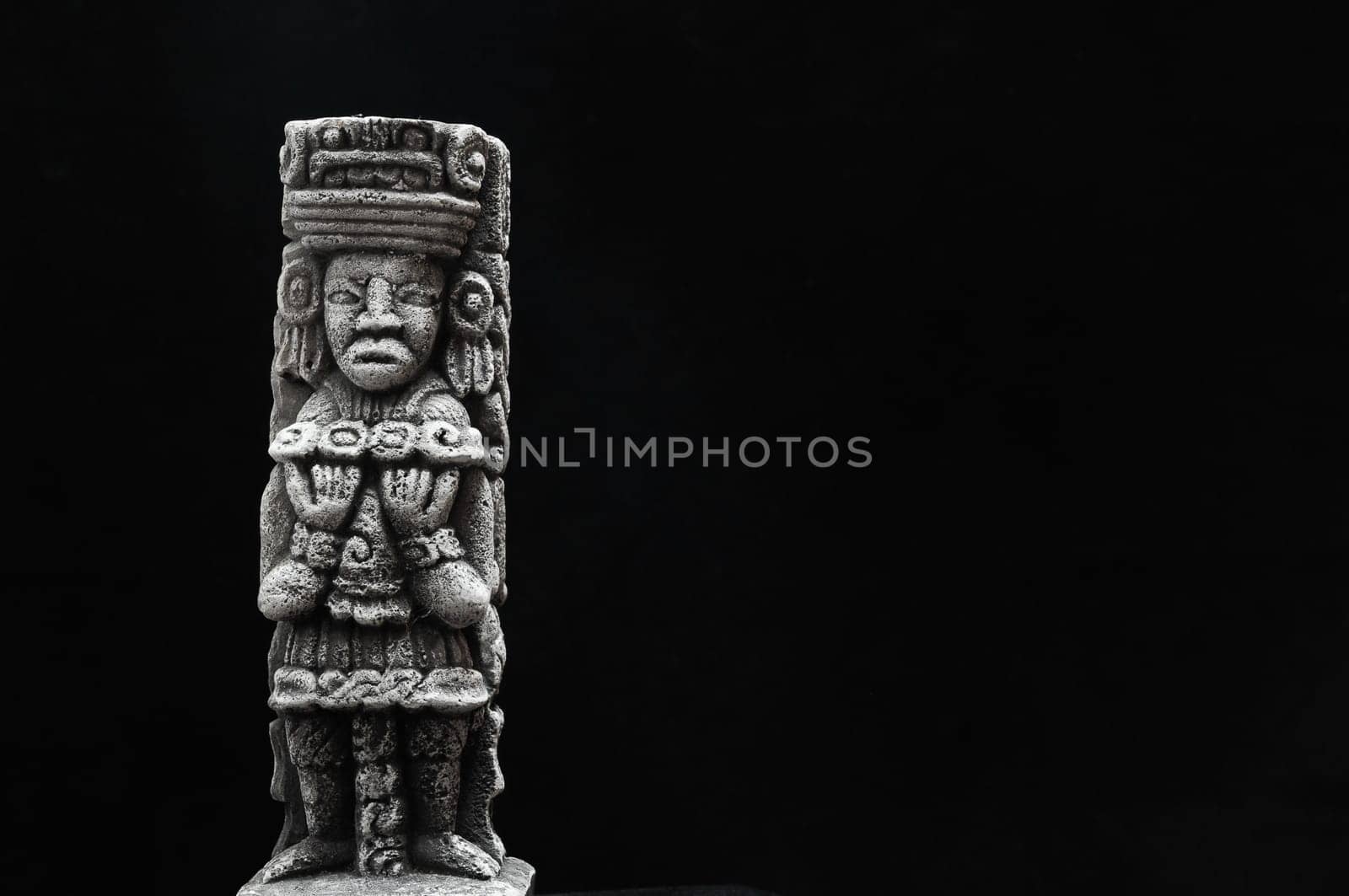 One Ancient Mayan Statue on a Black Background