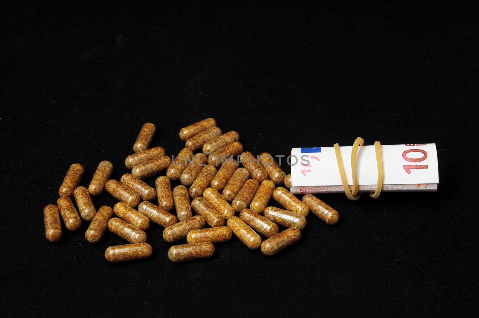 Some Pills And Money on a Black Background