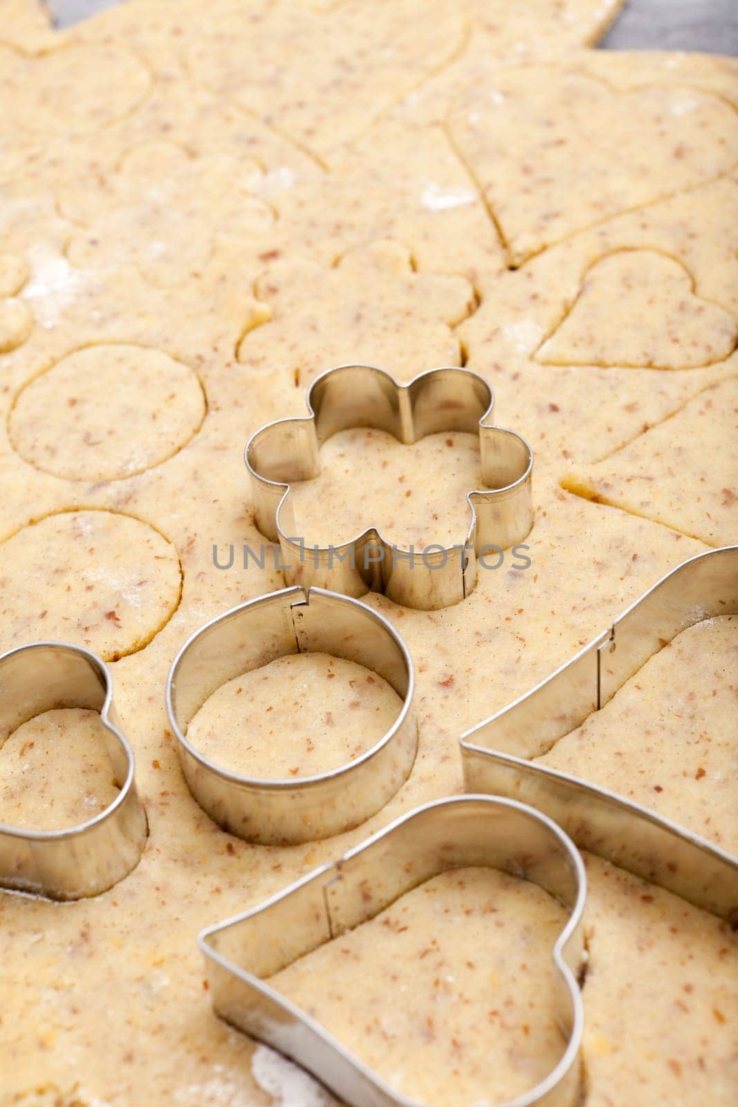 Various cookie cutters on cookie dough