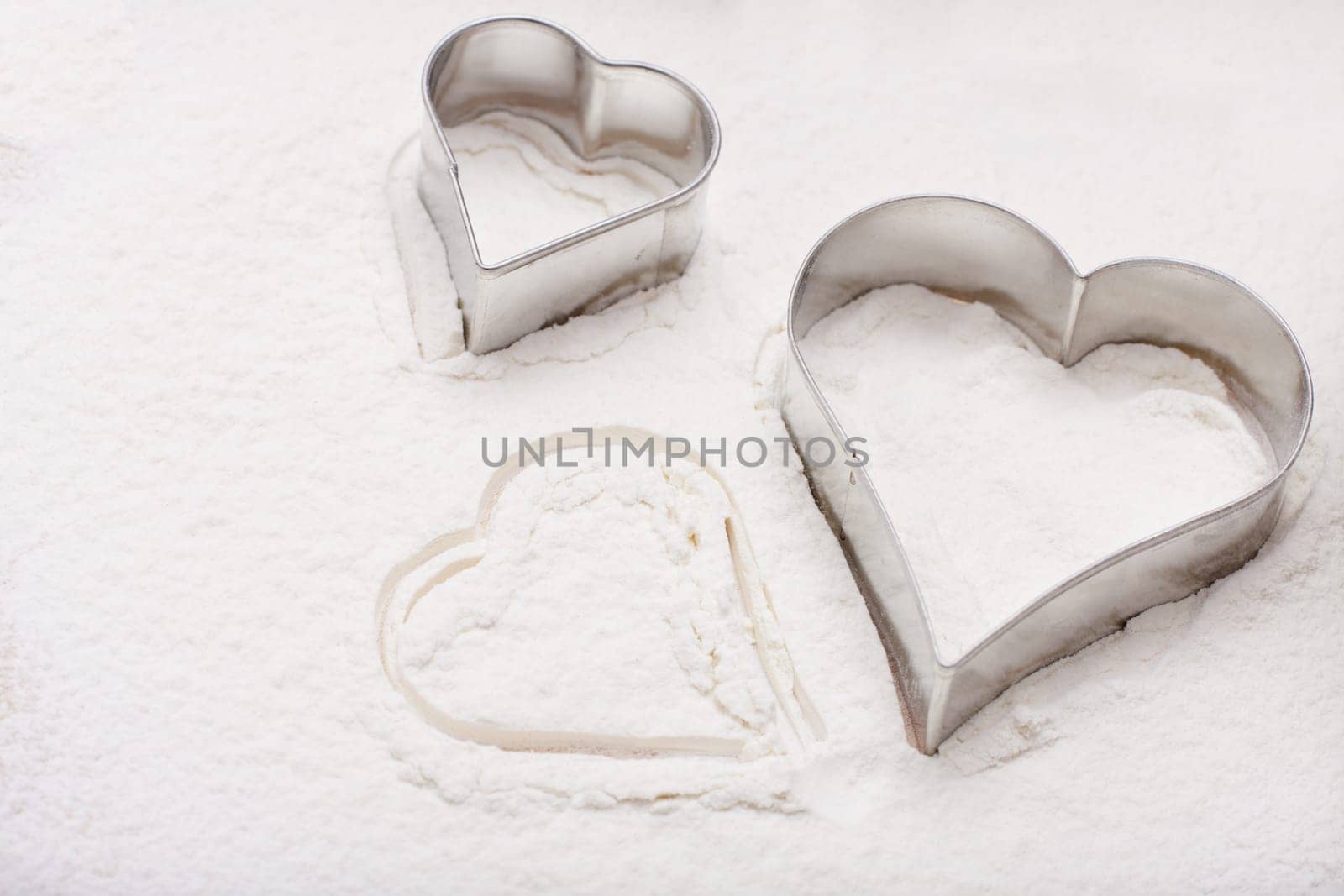 Heart cookie cutters in flour