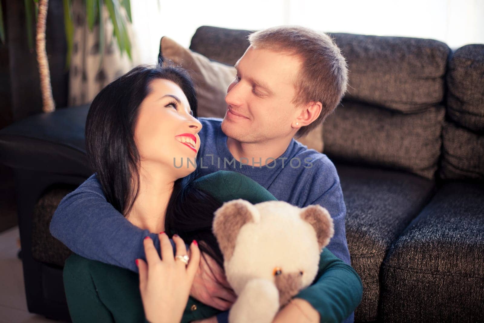 Happy young married couple in their house on valentine's day