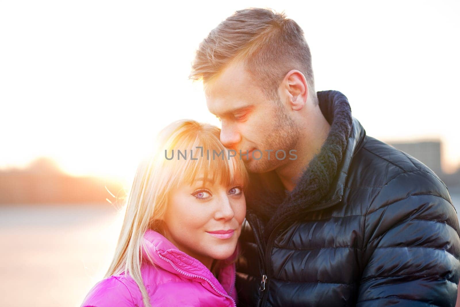 Young man embraces and kisses his girlfriend
