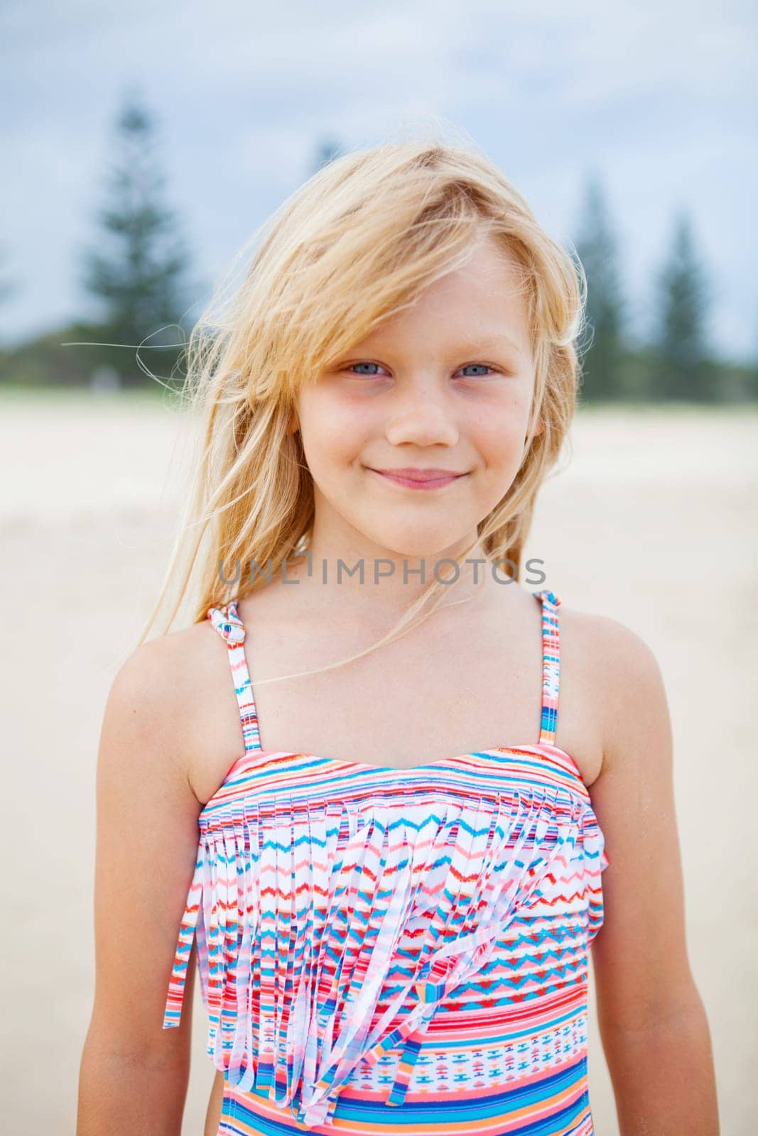 Portrait of cute young girl in swimming suit at the beach
