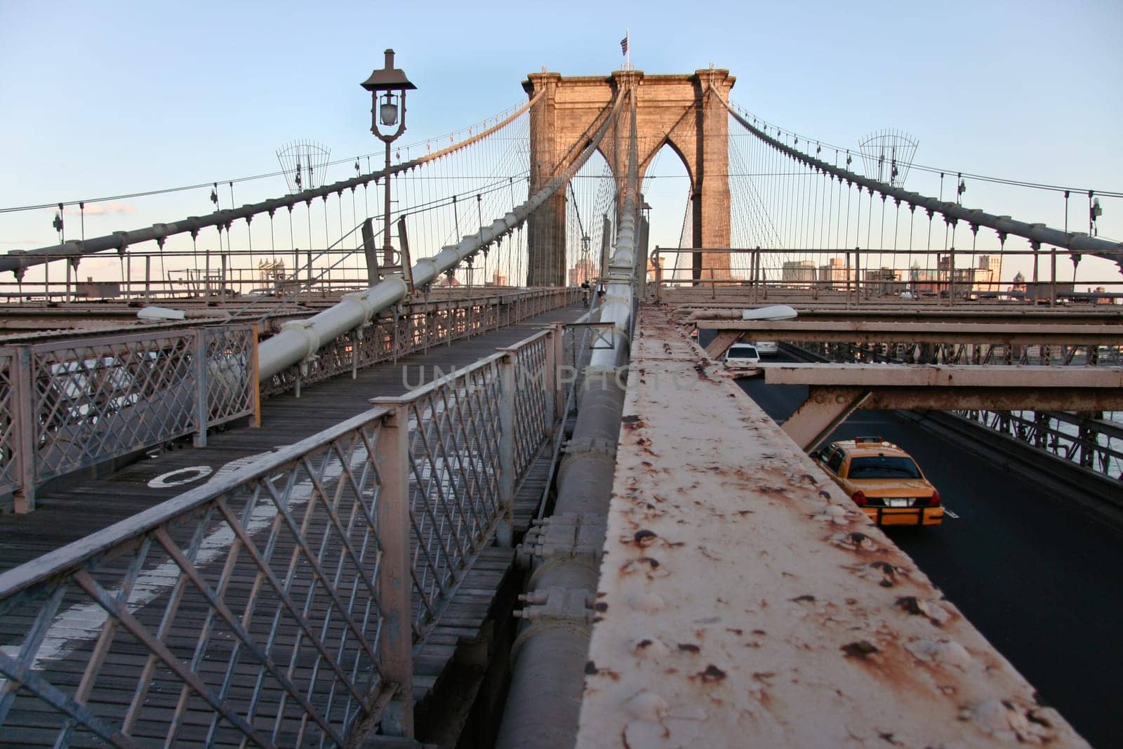 Rusty structure detail of brooklyn bridge  with pedestrian walk and road for cars, New York