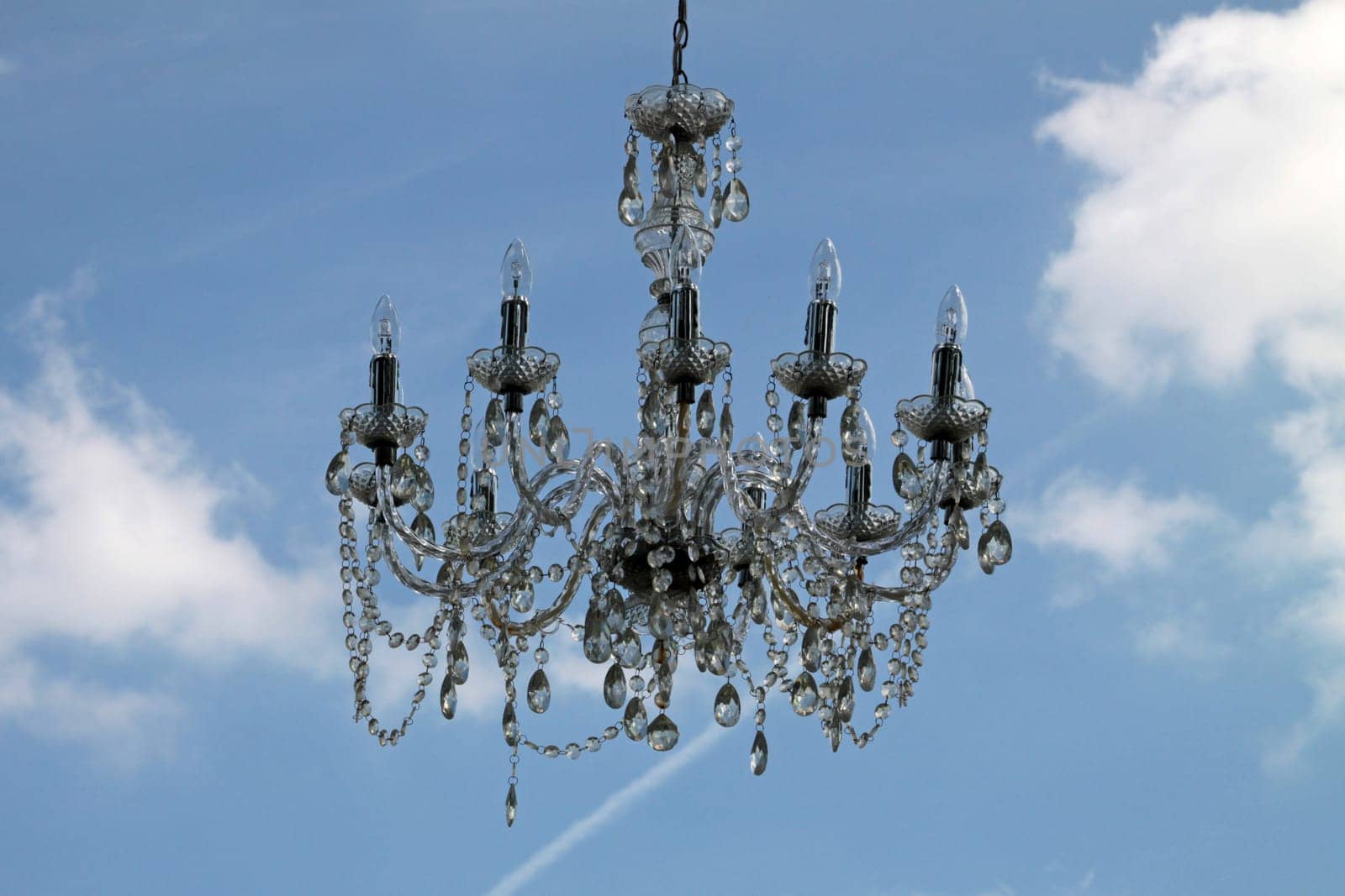 A chandelier hangs from the sky