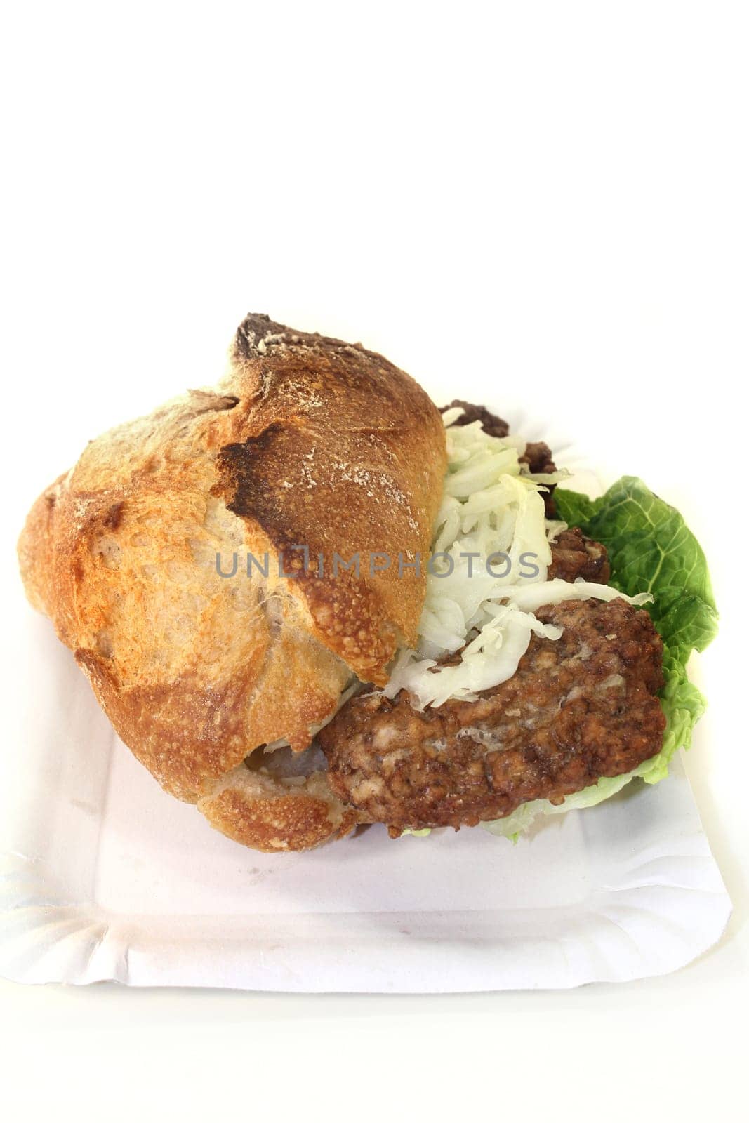 a bun with minced steak,white cabbage salad and salad