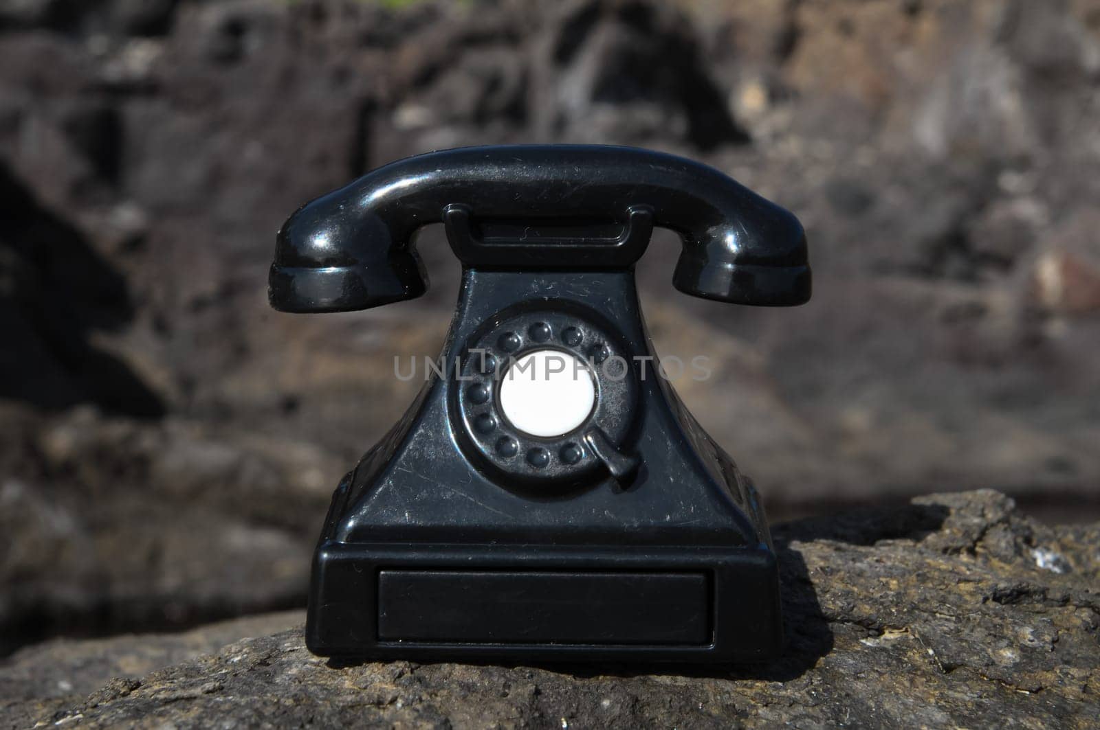 International Communications Vintage Telephone Toy on the Volcanic Rocks