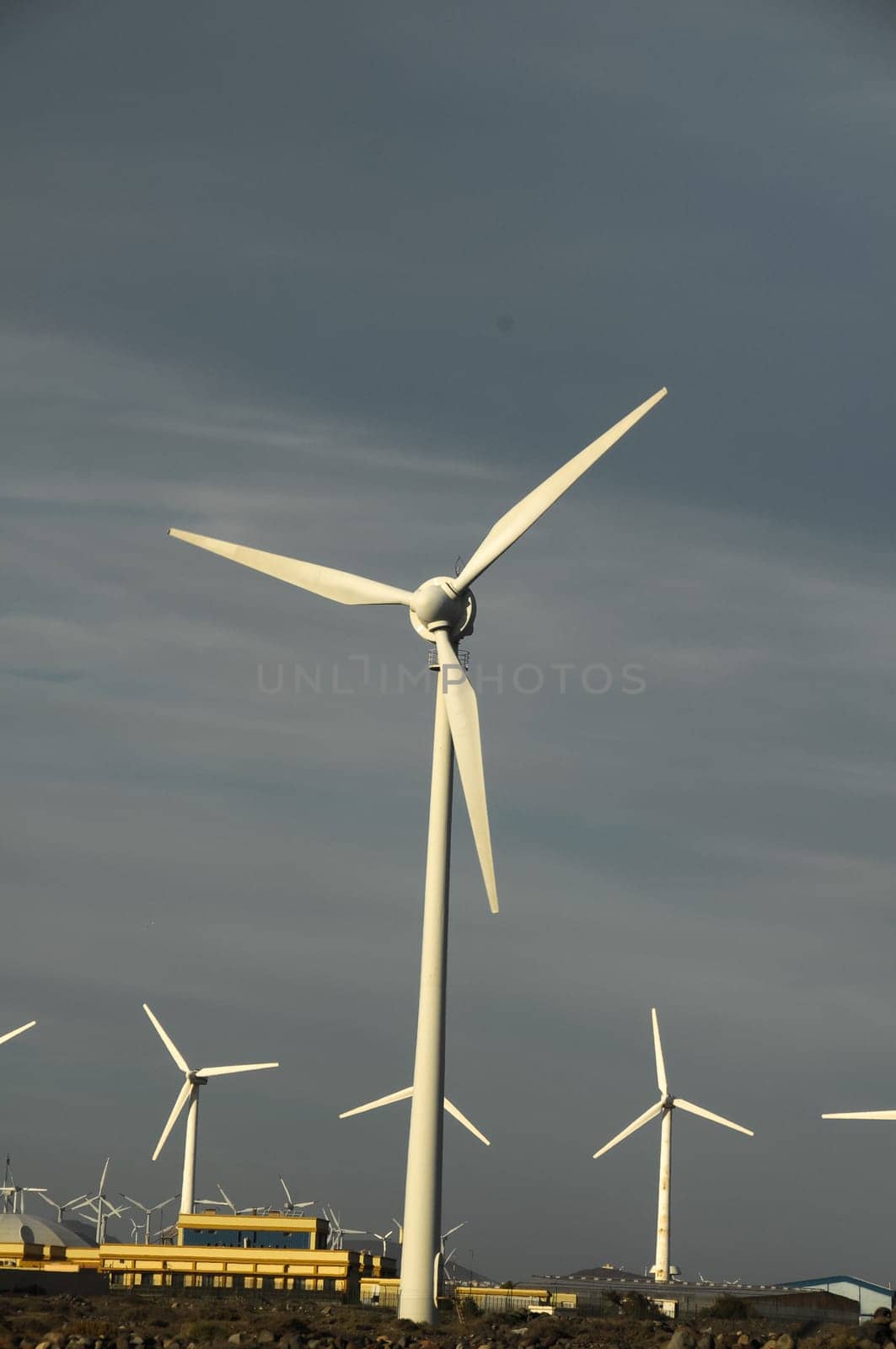 Eletric Power Generator Wind Turbine over a Cloudy Sky