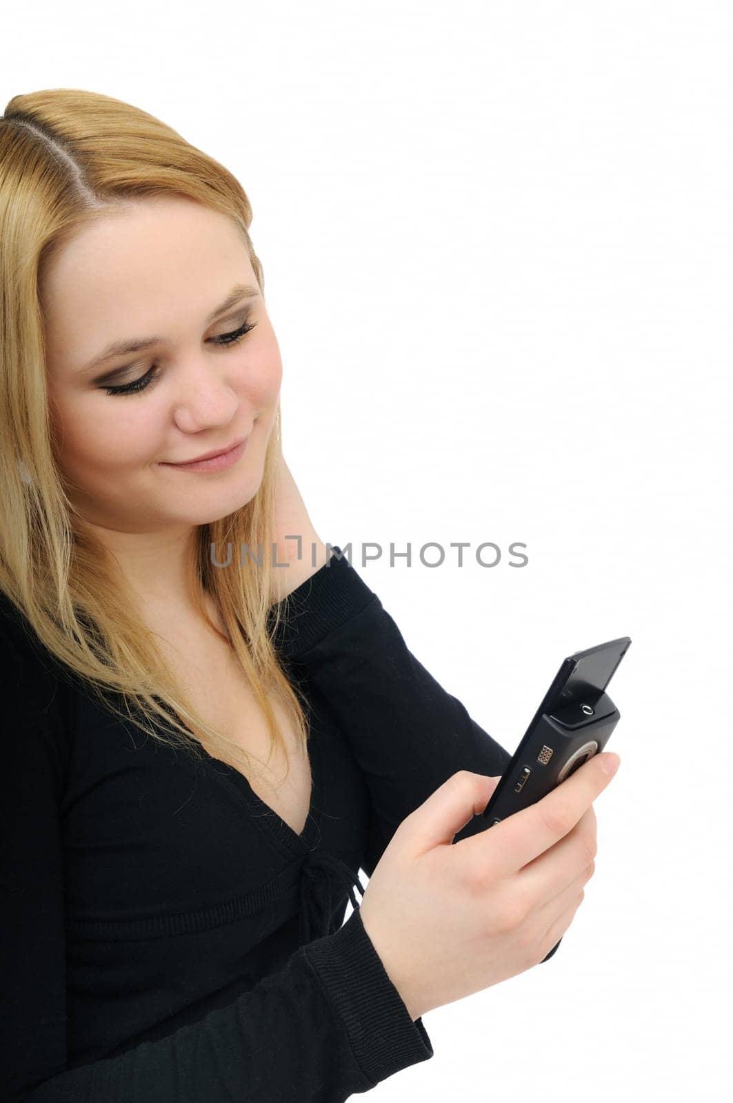 Blond smiling teenage girl holding mobile phone on white background