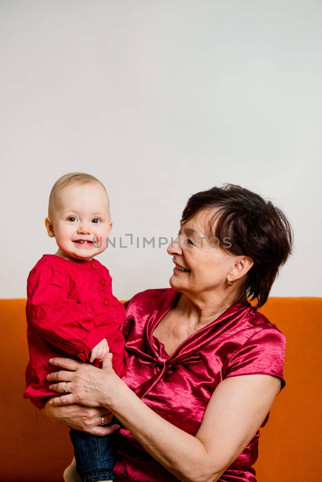Indoor portrait of grandmother with her grandchild with copy space