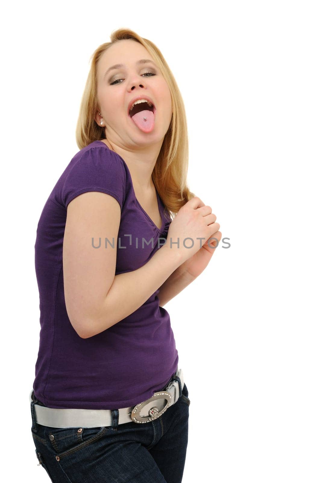 Blond teenager in jeans sticking her tounge isolated on white background