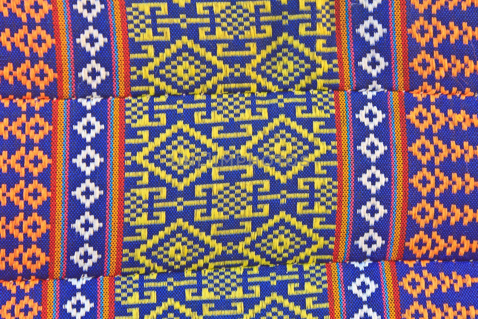 Thai Esan traditional pillows have a specific shape like cube and contain the pure cotton inside. The pillow surface has a specific weaving pattern and gaudy color. Handcraft art.