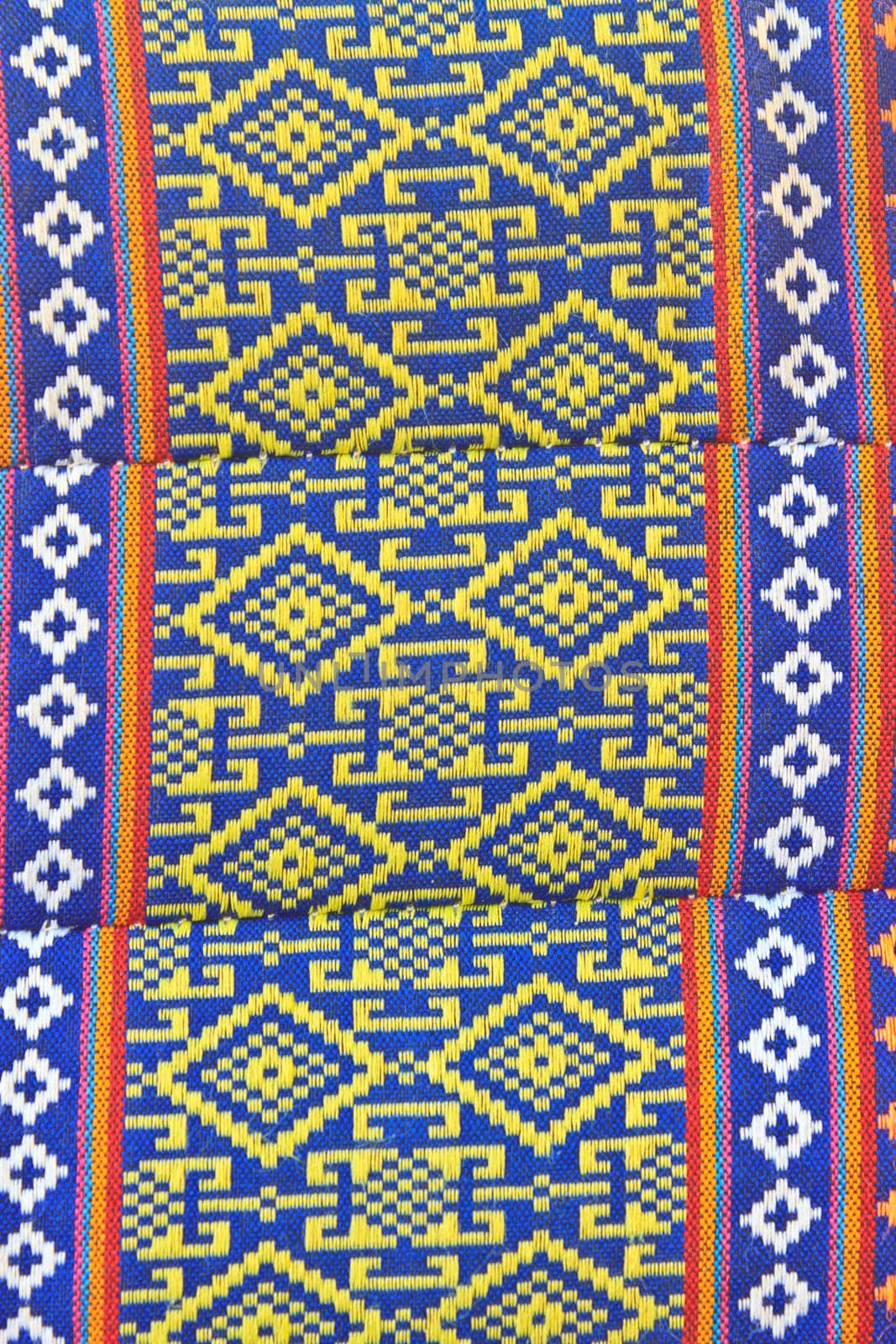 Thai Esan traditional pillows have a specific shape like cube and contain the pure cotton inside. The pillow surface has a specific weaving pattern and gaudy color. Handcraft art.