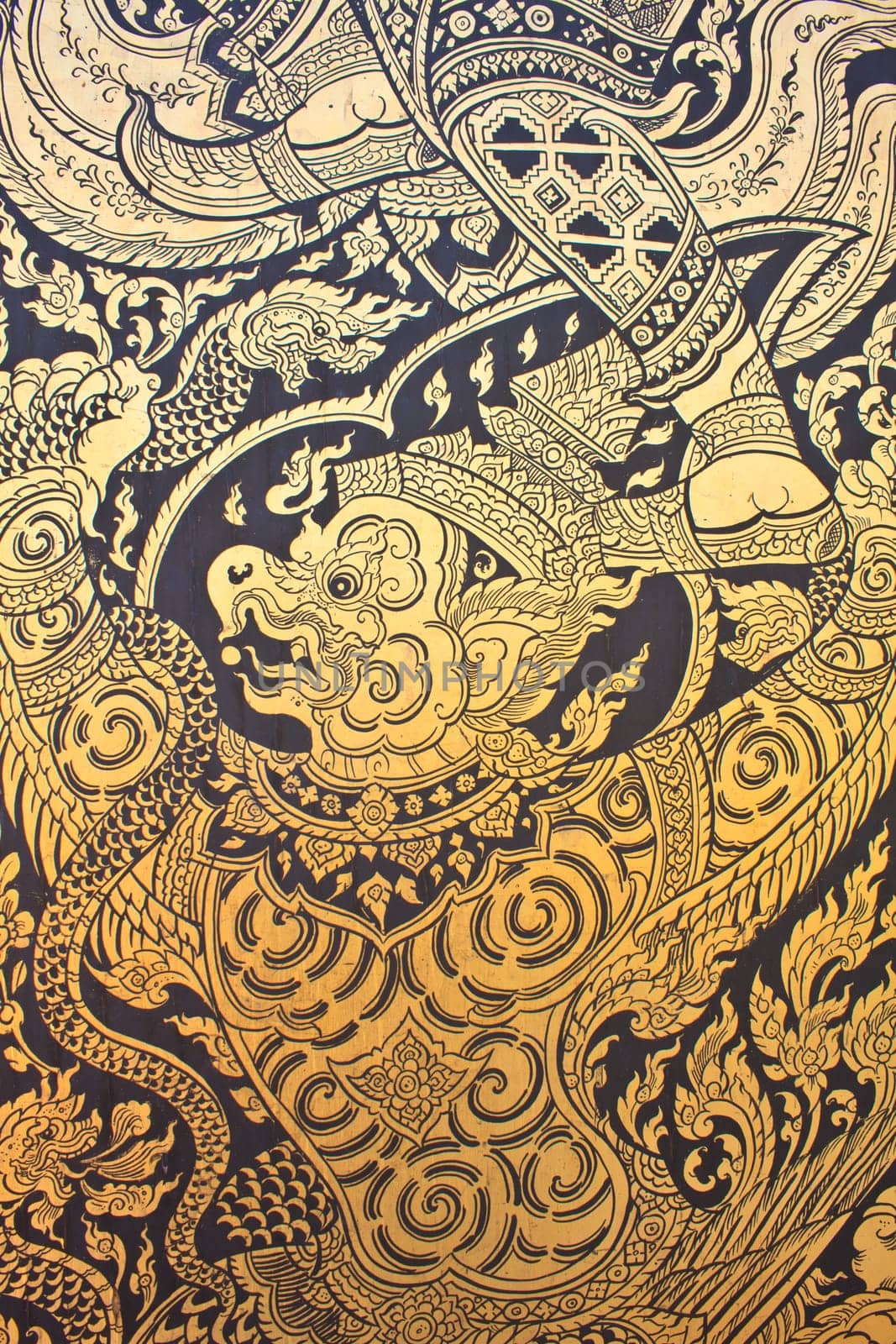 Traditional Thai style art gold painting pattern on the door in Temple Bangkok, Thailand