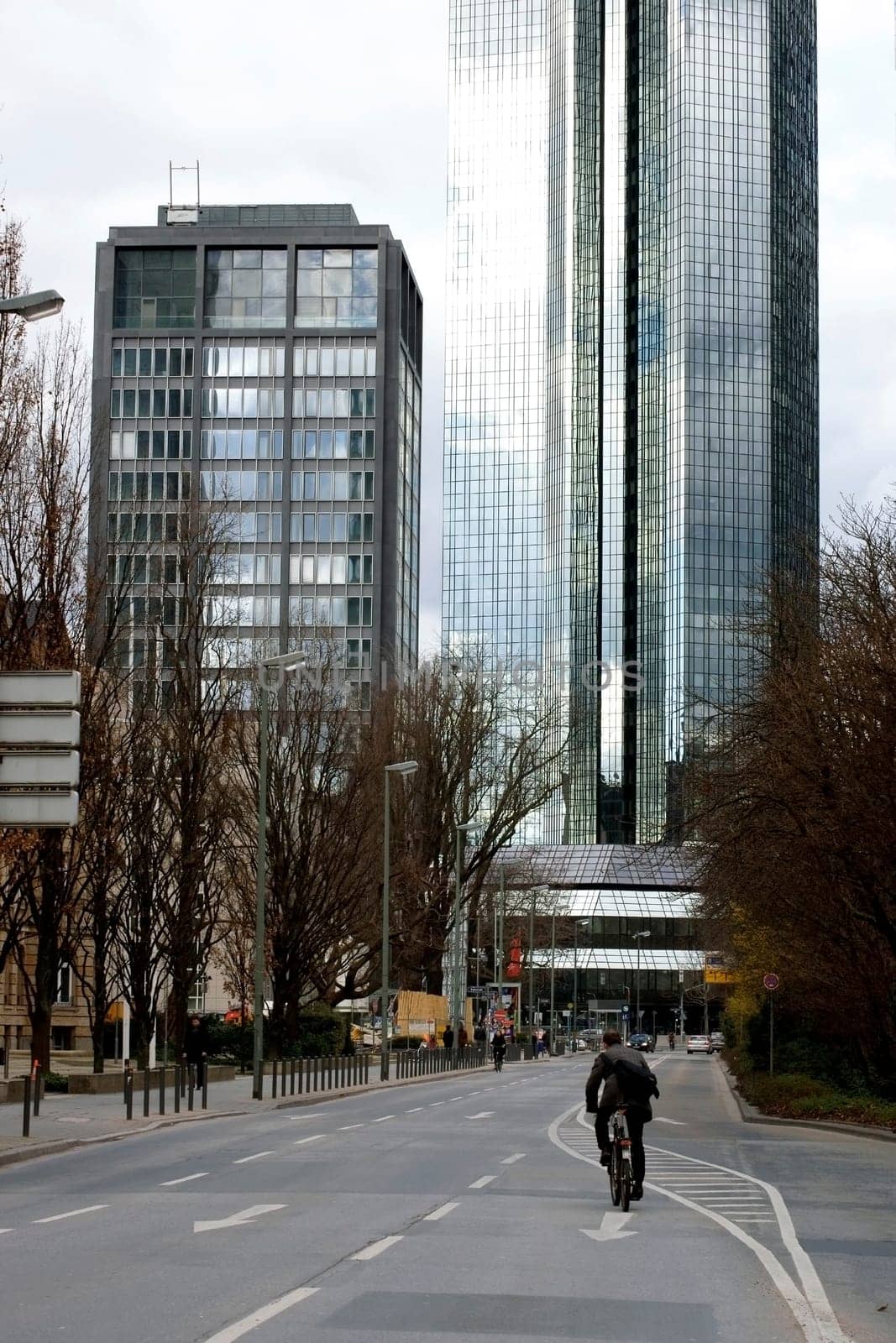 Frankfurt,Germany - February 19,2014: A cyclist rides on a main road towards the financial district on February 19,2014 in Frankfurt.