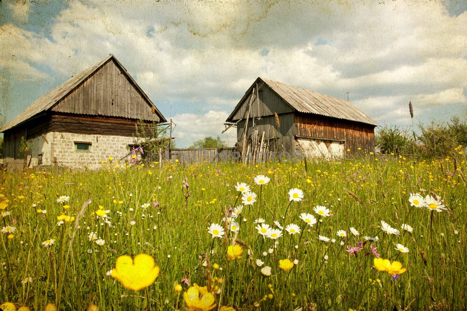 Vintage photo of old houses and spring field in the mountains