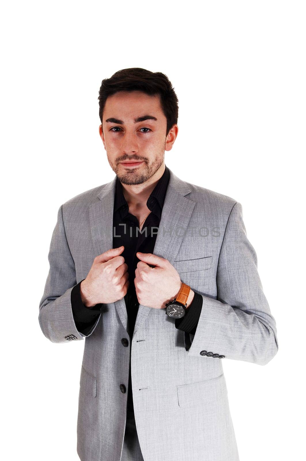 A handsome young businessman standing for white background in a gray .suit. .