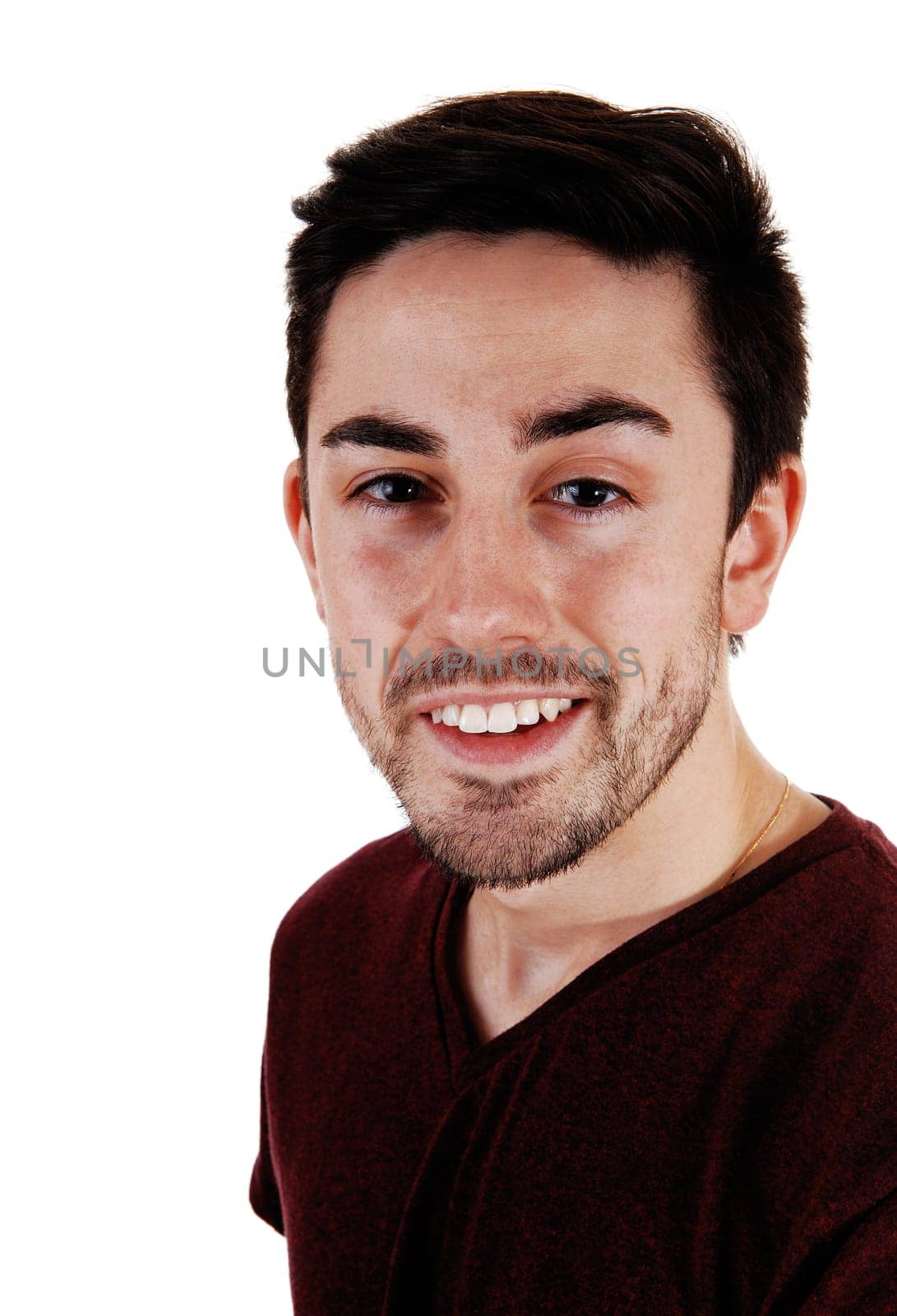 A young man standing for white background very relaxed .in a portrait picture with a beard..