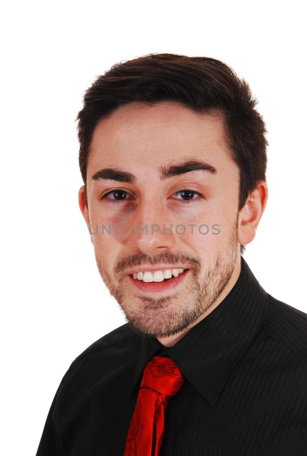 A closeup picture of a young man in a black shirt with red tie smiling into.the camera with a beard, for white background..