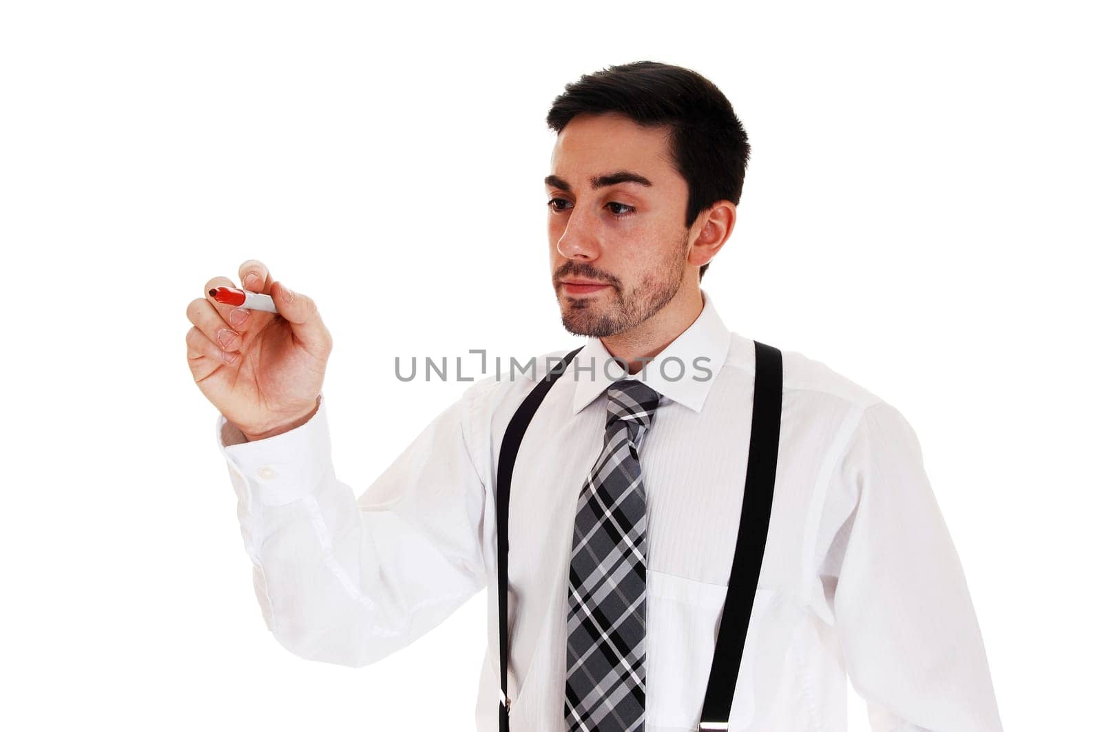 A young man in a white shirt and black tie and suspender writing on.a glass wall, for white background..
