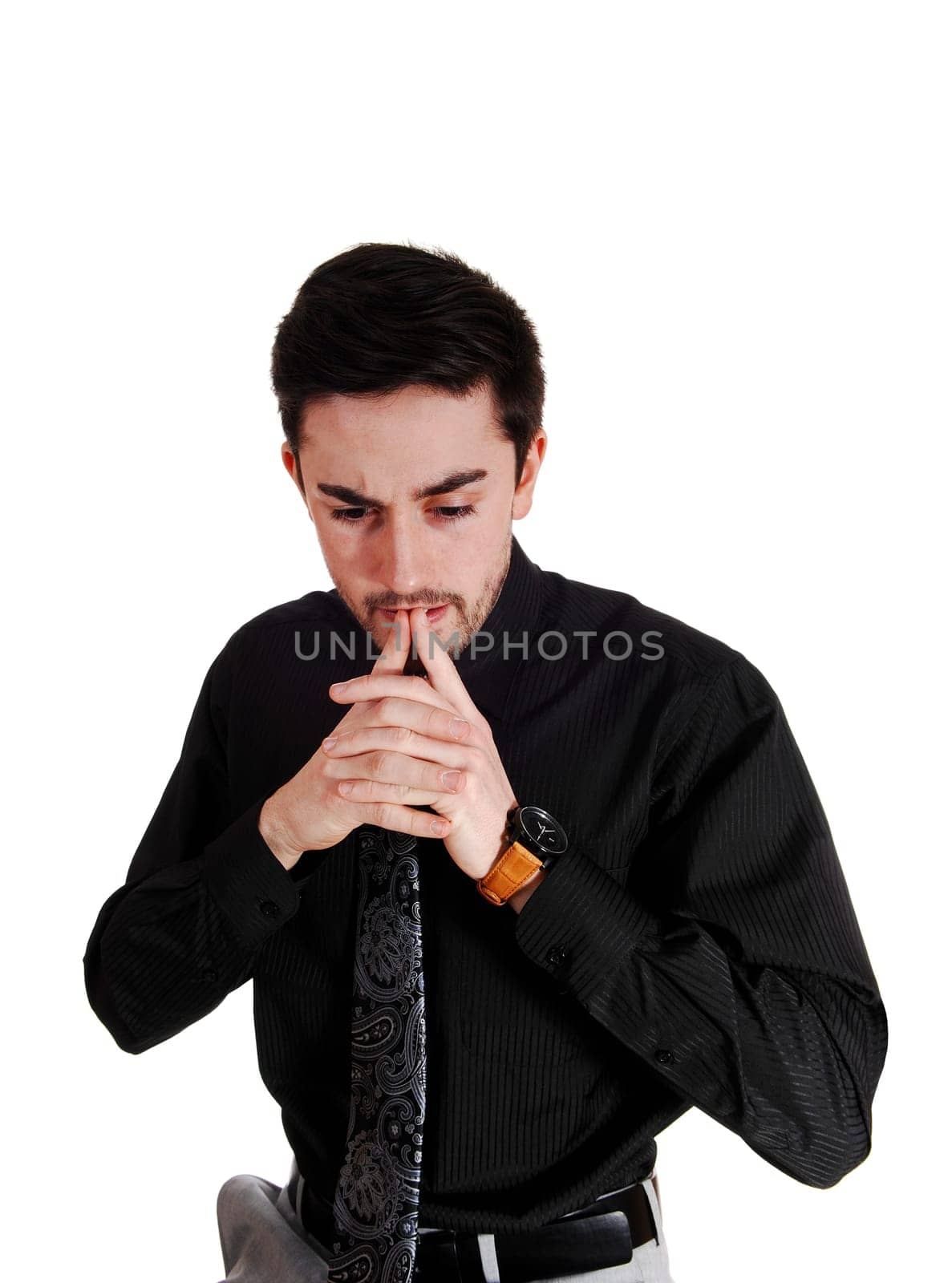 A young man in a black shirt and red tie with his fingers on his chin, thinking,.for white background..