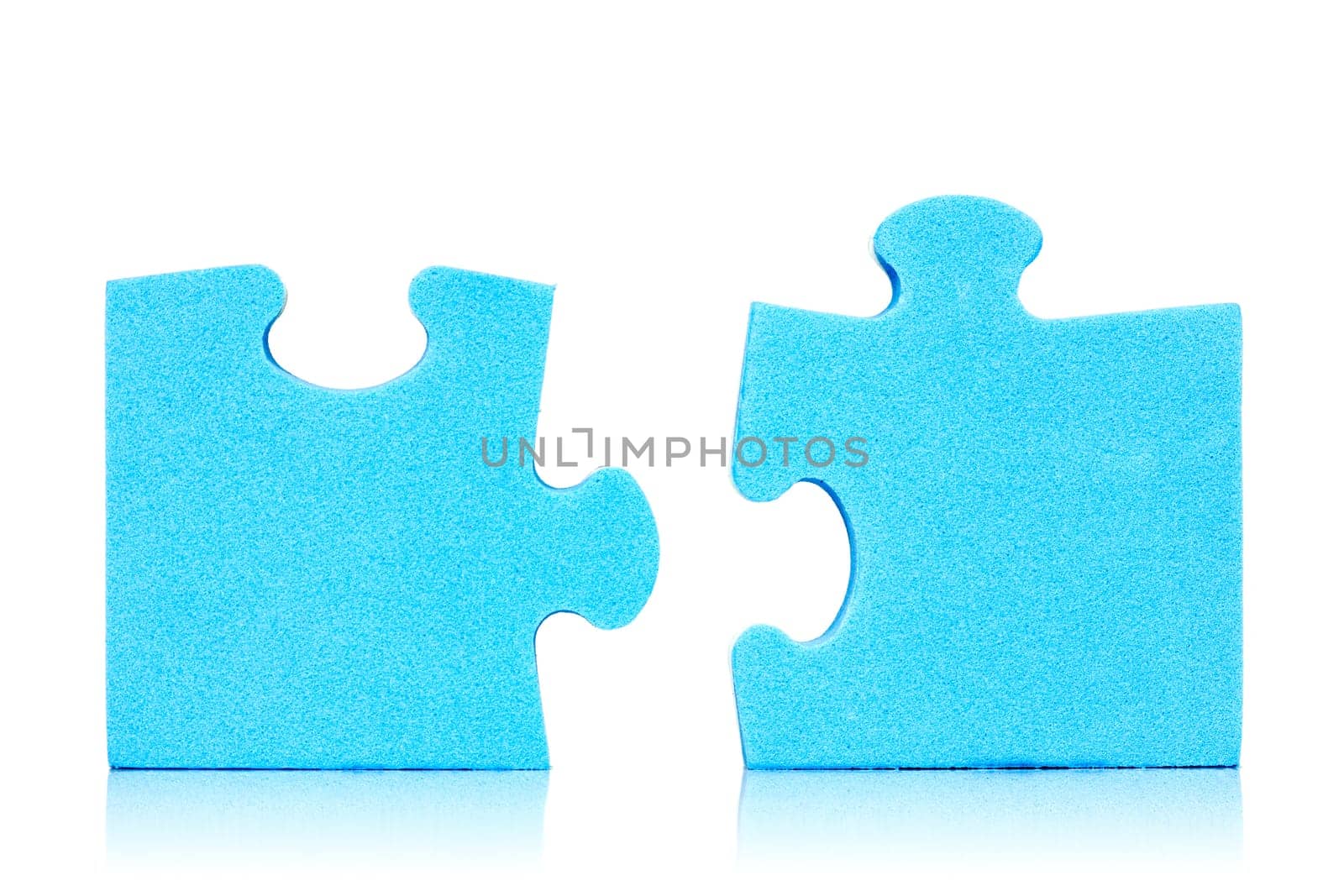 Connection metaphor. Two  pieces of blue puzzle on white background