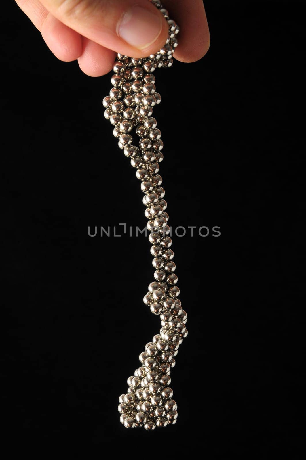 Lot of Round Magnetic Spheres on a Black Background
