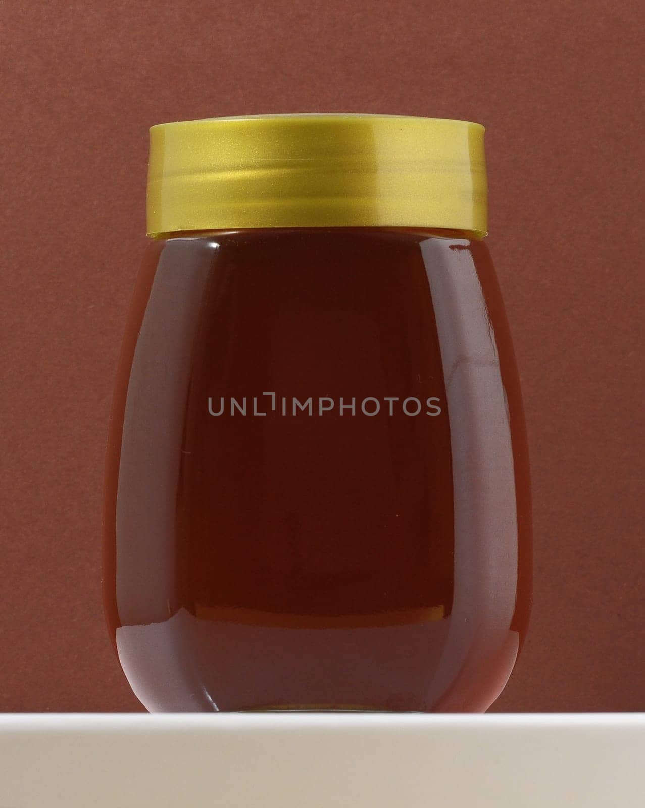 One Full Honey Jar on a Colored Background