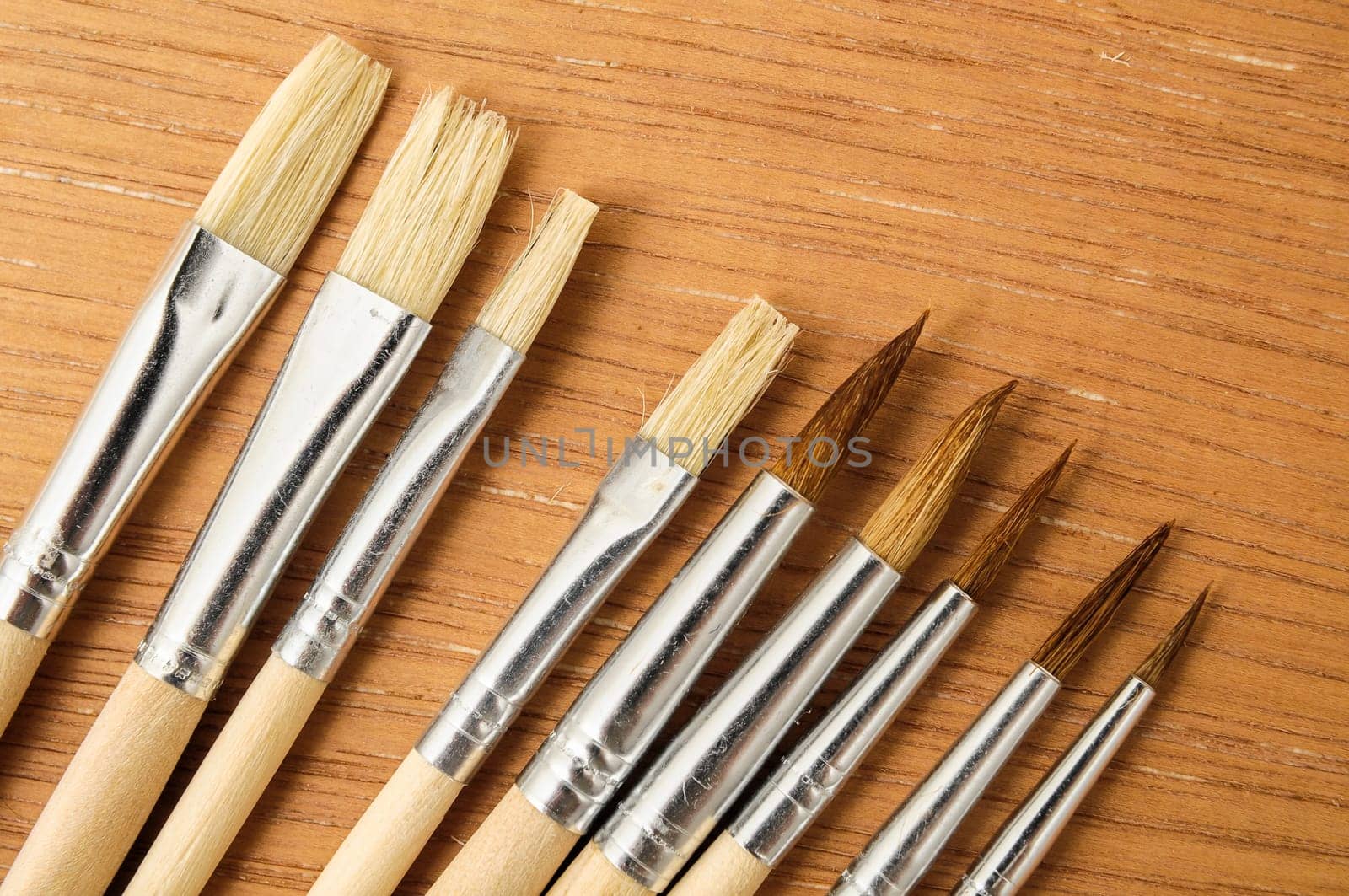 New Wooden Different Paintbrush Set Texture over a Colored Background